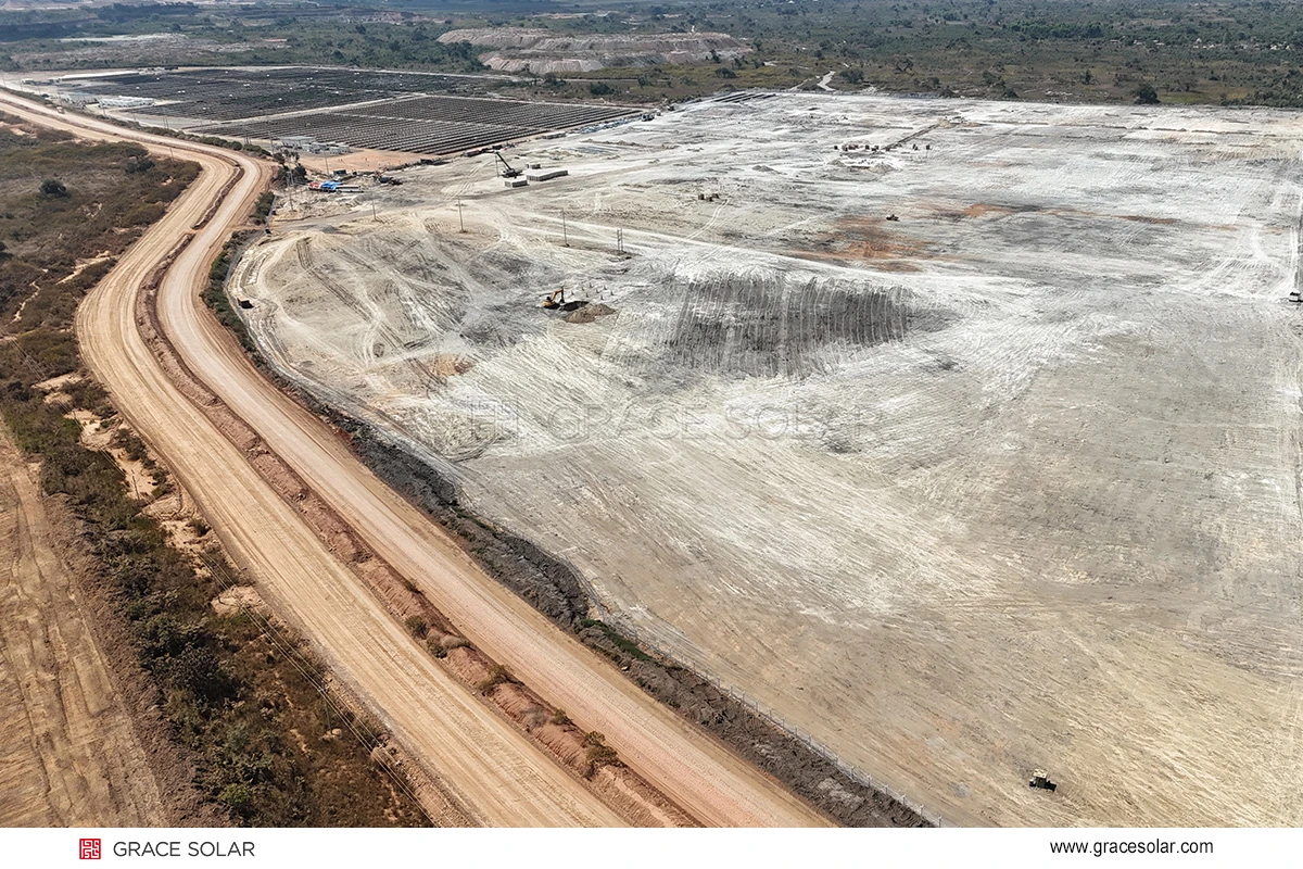 Congo solar project site preparation with completed ground mounts in background