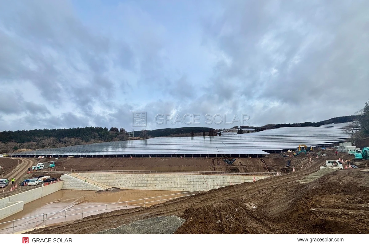 Large-scale solar array at Kumamoto mountain project showing extensive ground mount installation