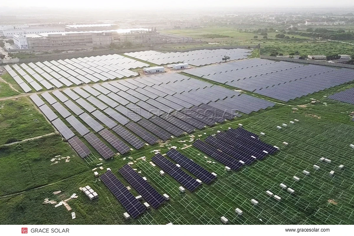 Completed 12MW solar power plant in Pakistan showing extensive panel array under clear skies